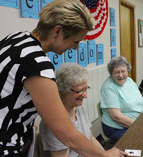 Photo by Mike Brothers Moultrie Douglas Extension educator Cheri Burcham introduces Judy Brown to the first of the Memory Game story cards. Brown had a lion card, and she went to the zoo. Nina Glazebrook had to remember Brown’s story while adding her own story to the list as they traveled around the table at Mid-Illinois Senior Center in Sullivan last week.