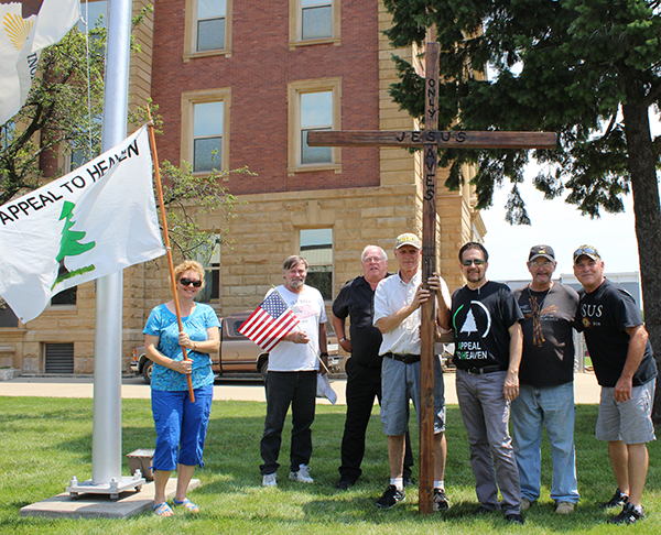 Photo by Mike Brothers A group touring the state with An Appeal to Heaven stopped in Sullivan last week. Pictured following prayer at the Moultrie County Courthouse flagpole from left to right Christiane Sheets, Roy Lyerla, Moultrie County Courthouse officer Mike Brewer, Jim Skaggs, Pat Sheets, Ron Turnbow, Lee Clawson.