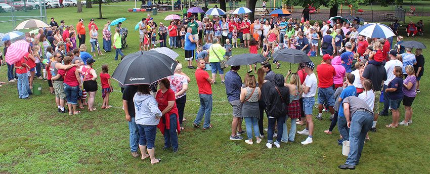 Photo by RR Best Rainy Races Crowds gathered under umbrellas for the 2 p.m. Fourth of July turtle races at Wyman Park in Sullivan. In spite of threatening weather, events continued during the Independence Day celebration. Everything from the parade and games to a fantastic fireworks display sponsored by the Sullivan American Legion Post #68 went off as planned.