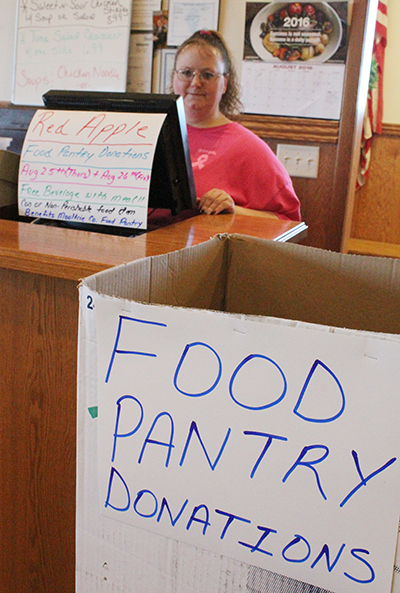 Photo by Mike Brothers Red Apple Donates With the Moultrie County Food Pantry needing food donations, the Red Apple Family Restaurant in Sullivan is collecting canned and other non-perishable food items Thursday and Friday, Aug 25-26. Customers who donate items to the Food Pantry collection box in the restaurant will receive a free (nonalcoholic) beverage with their meal. Red Apple coordinator for food pantry donations Stephanie Hays explained the Moultrie County Food Pantry helps a lot of people in the community, and the restaurant is happy to support such a worthy service.