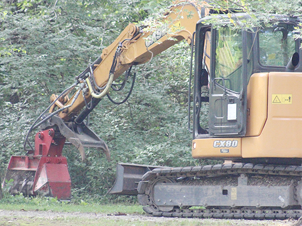 Photo by Mike Brothers Large brush clearing equipment was contracted to help clear Asa Creek in Tabor Park