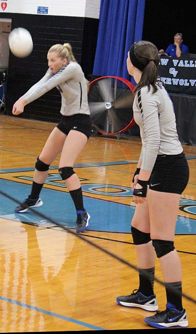 Photo by Mike Brothers Kristy Burford sets up return with Kate Jeffers in Okaw Valley volleyball match with Arcola Sept. 22 in Bethany. 