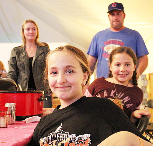 Photo furnished Young Chili Cookers Not to be outdone by the adult chili cook off participants two Sullivan students decided to compete. Above Addison Minor (front) and Taylar Mercer combined hamburger, tomato sauces and juice, salsa and a variety of seasonings in the blend that would make any first year chef proud. Mercer’s father Jerod and mother Nichole (background) assisted in the cooking set up, but the girls developed the recipe and prepared all ingredients.