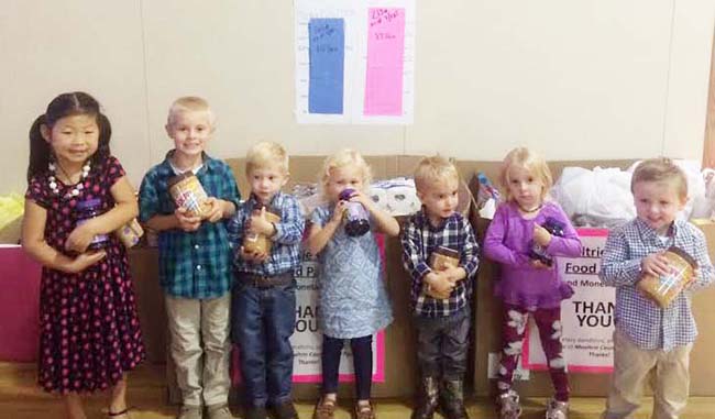 Photo courtesy Heather Clements UMC Kids Spread Cheer to Food Pantry Pictured are children from the Sullivan First United Methodist Church with jars of peanut butter and jelly that were collected over this last month for the local food pantry. From left to right: Adalee Foster, Vance Young, Leo Lane, Livie Lane, Henry Kuhns, Scarlett Perrott and Judd Sanner. Church members and children were challenged to fill several large boxes to supply the food needs for the month of September for the food pantry. The children were also in a contest to collect a total of 300 pounds of peanut butter and jelly (150 lb. of peanut butter for boys, 150 lb. jelly for girls). The kids surpassed their goal by collecting 164 lb. of peanut butter and 213 lb. of jelly in hopes of “Spreading the Word” to the community of Sullivan and helping those in the community. 