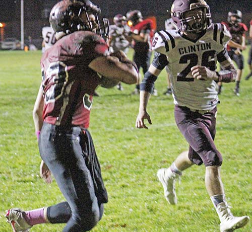 Photo by Mike Brothers Freshman quarterback Luke Harlan connects with Bryce Farris on this two point conversion that put the Redskins within one point of Clinton Sept. 30.