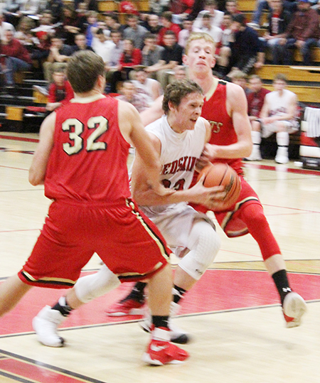 Photo by Mike Brothers Sullivan’s Bryce Farris drives between ALAH defenders Hunter Day and Colton Romine during the Nov. 23 Knights 29-26 win over the Redskins.