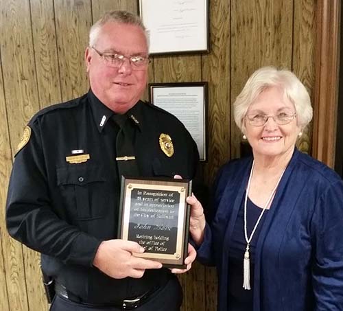 Photo furnished Chief John Love accepts appreciation plaque from Mayor Ann Short at a recent city council meeting. Chief Love begins retirement November 23 after serving the city of Sullivan for 28 years.