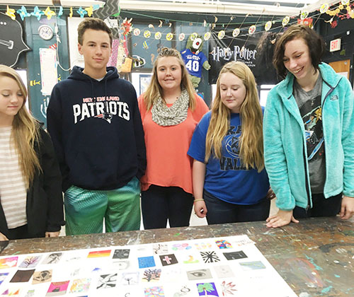 Photo by Ellen Ferrera-Dick OVHS students Destiny Underwood, Cameron Nickerson, Savannah Gibbons, Kelly McGill and Chloe Wirey check out the trading cards that will help them contact students from around the world and around the area.