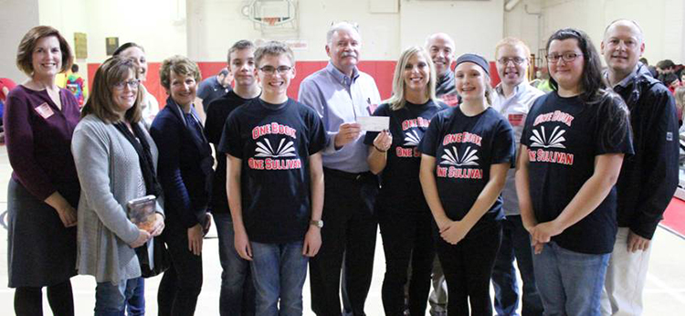 Photo by Mike Brothers One Book One Sullivan Funded Sullivan Rotary funds the One Book One Sullivan project at Sullivan Middle School.  Pictured during the Nov 23 school assembly announcement of this year’s selection,The Paper Cowboy, were Rotary members and OBO students from left to right: Julia Beals, Susan Rauch, Laurrie Minor, Lori Shasteen, students Brett Johnson and Reagan Crouse, Rotary president David Cole, One Book One Sullivan coordinator Rikki Ray; Rotary members in back: Stan Parks, Dan Fultz, and Joe Keller with OBO students Carley Towle and Loren Harner in front.