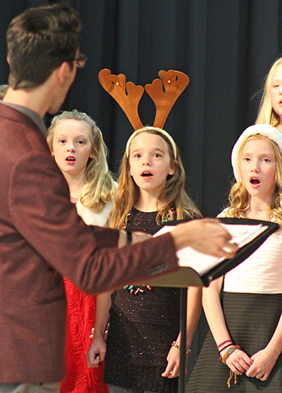 Photo by RR Best Holiday Concert Sullivan Middle School was the scene of the holiday concert held this past weekend. Mr. Jeff Thomas and Mr. Brock Freece coordinated the school wide musical event played to a capacity crowd. Above Thomas leads: (left to right) Molly Dendy, Natalee Hunter, and Rylee Roehrs sing a special holiday tune.