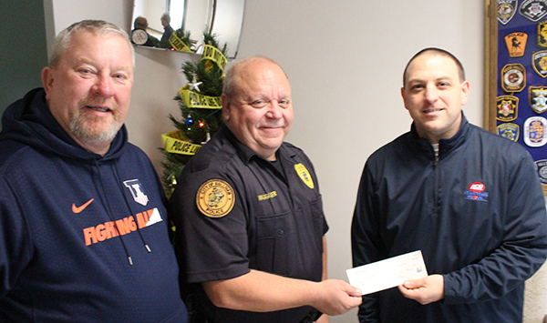 Photo by Mike Brothers Sullivan IGA manager Pat Stinson (right) presents $500 check to Moultrie County Secret Santa representatives Police Chief Jim Waggoner and Greg Foster. 