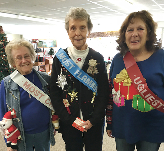 Photo by Ellen Ferrera Above are winners of the ugly sweater contest. Pictured left to right are Peggy Booker (most creative), Shirley Devore (most flammable), and Pam Mann (overall ugliest).