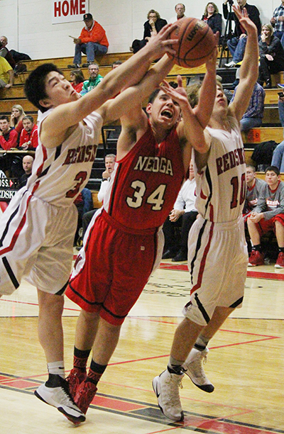 Photo by Darian Hays Sullivan Redskins Ricky Yang and Queintan Britton fight for a rebound during the home game against Neoga Dec. 9.